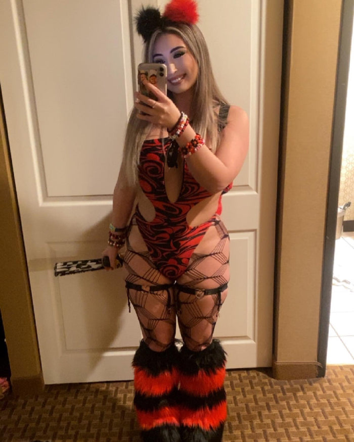 Model wearing black and red faux fur Space Bunz hair clips with matching rave outfit and furry leg warmers.