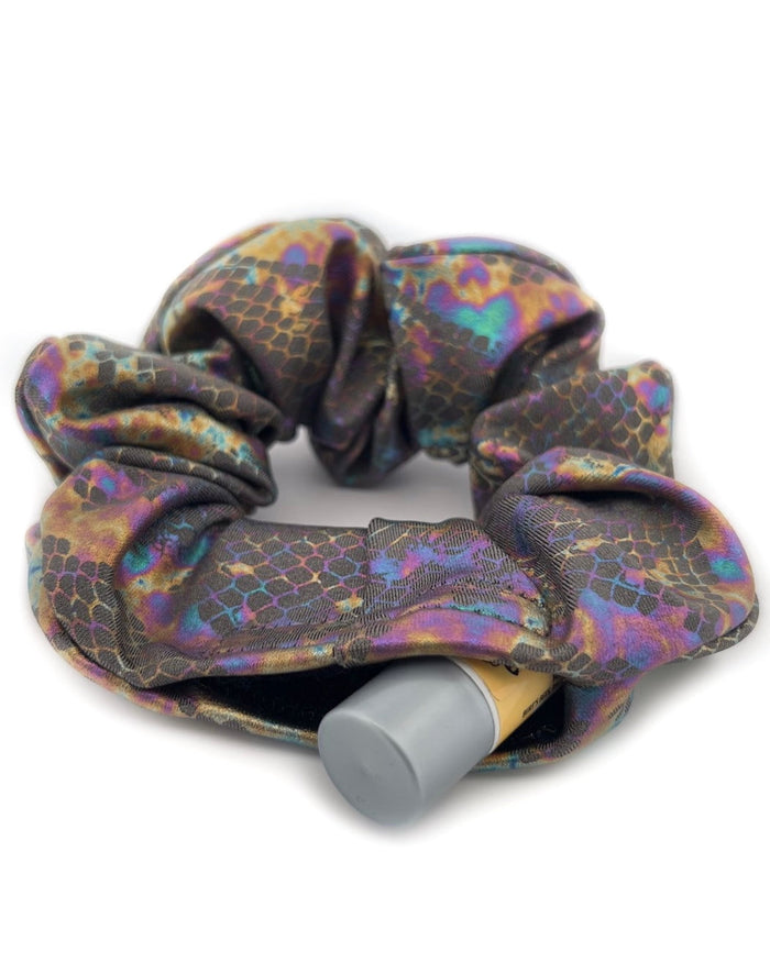 Close-up of the Prismatic Venom Stashie’s hidden Velcro® pocket, showing space for keys, cash, or chapstick. One Stop Rave.