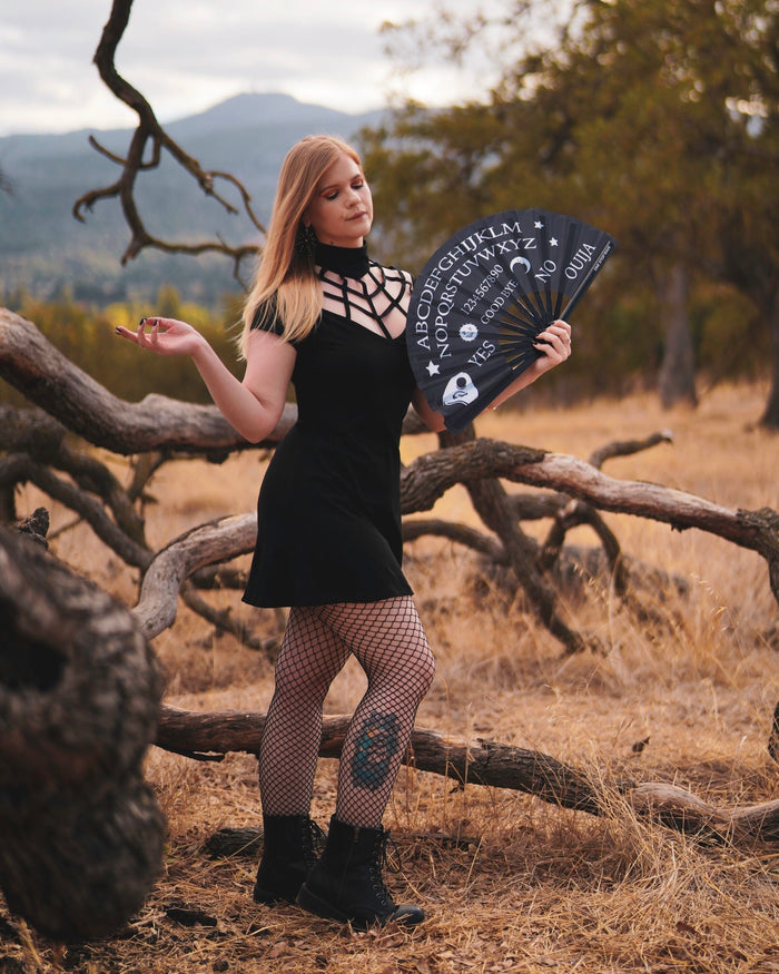 Wake the Dead hand fan held by woman in gothic festival outfit